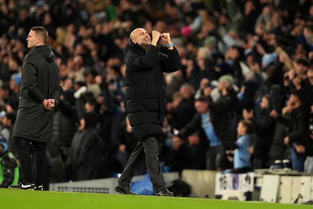 Pep Guardiola clenches his fists and looks up to the skies to celebrate a goal