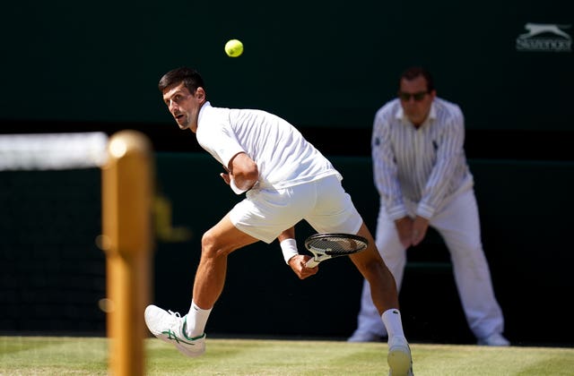 Novak Djokovic plays a shot through his legs