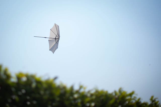 An umbrella blown away by a gust of wind