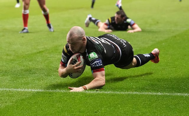 Wigan winger Liam Marshall slides in to score a try