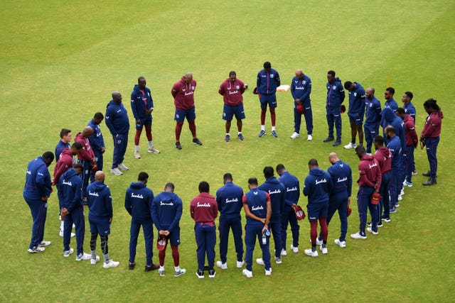 The West Indies team observe a moment of silence