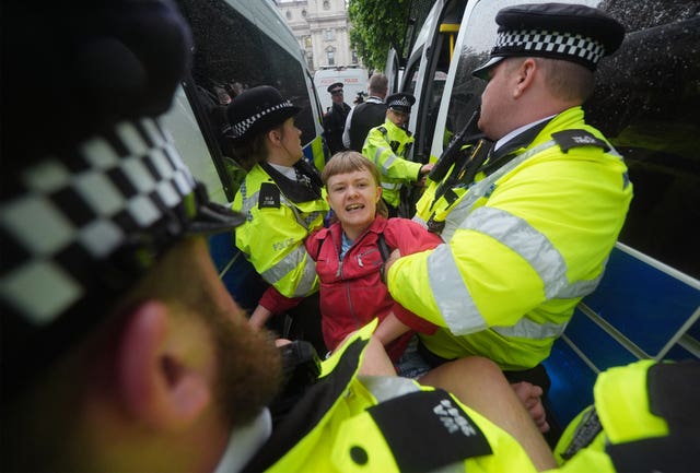 A person being detained by police officers