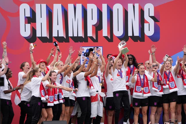 England captain Leah Williamson, centre right, lifts the trophy with team-mates