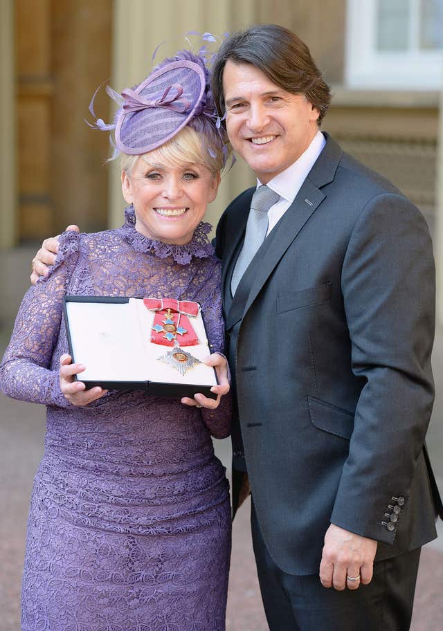 Barbara Windsor and her husband Scott Mitchell following an investiture ceremony at Buckingham Palace