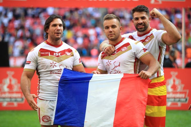 Josh Drinkwater (centre) celebrates winning the Challenge Cup with Catalans