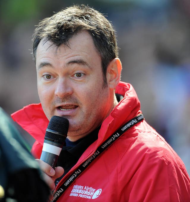 Grant Stott speaks into a microphone