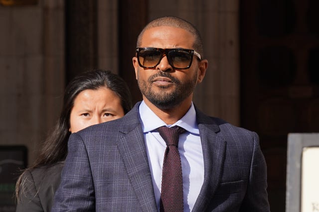 Noel Clarke in suit and sunglasses