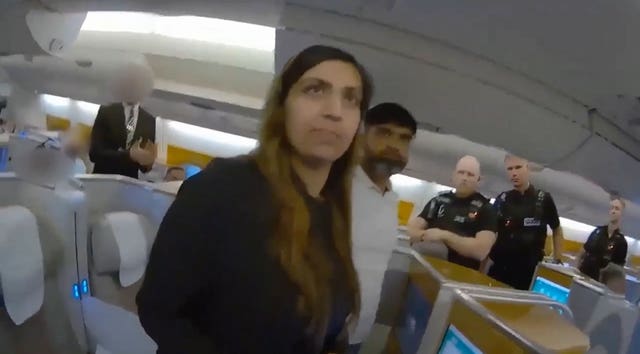 A still from from body cam footage of the moment police boarded a plane and detained Beinash Batool at Gatwick 