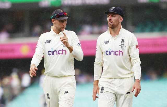 England’s Joe Root (left ) and Jack Leach walk off as rain stops play