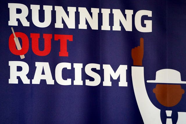 A Running Out Racism banner