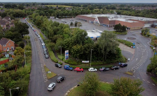 Motorists queue for a petrol station to open at a Tesco in Ashford, Kent