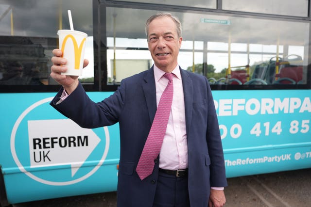 Reform UK leader Nigel Farage holding a McDonald's banana milkshake after one was thrown at him in Essex 