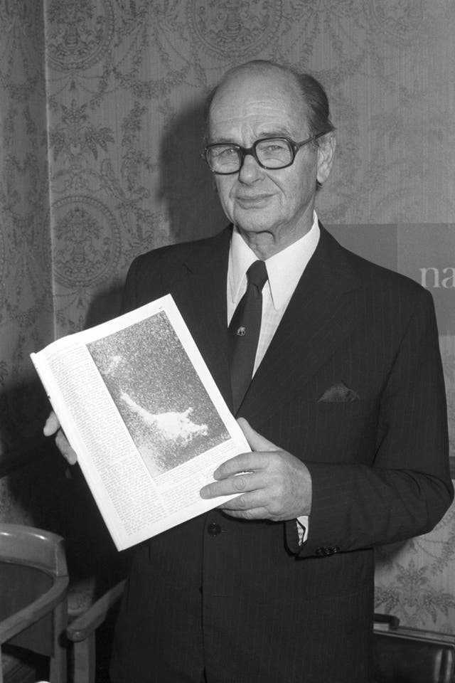 Peter Scott holds up a picture of the Loch Ness Monster