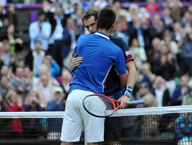 Andy Murray hugs Novak Djokovic at the net