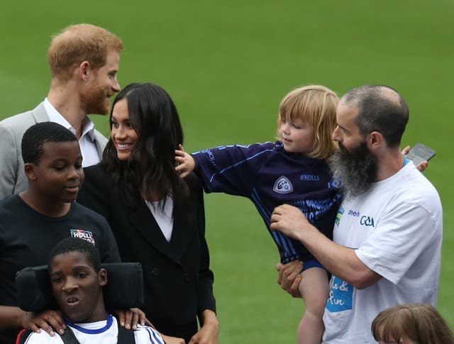 A boy reaches out to touch Meghan's hair during the visit to Croke Park (Brian Lawless/PA) 