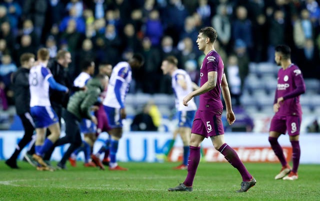 City's quadruple hopes were ended at Wigan on Monday