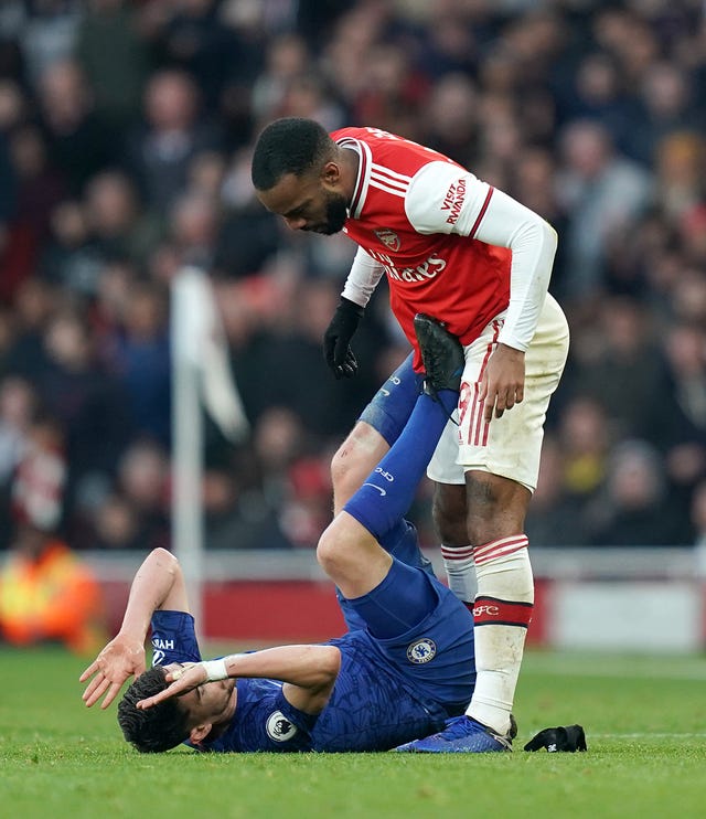 Arsenal's Alexandre Lacazette, right, reacts to a challenge from Chelsea's Jorginho