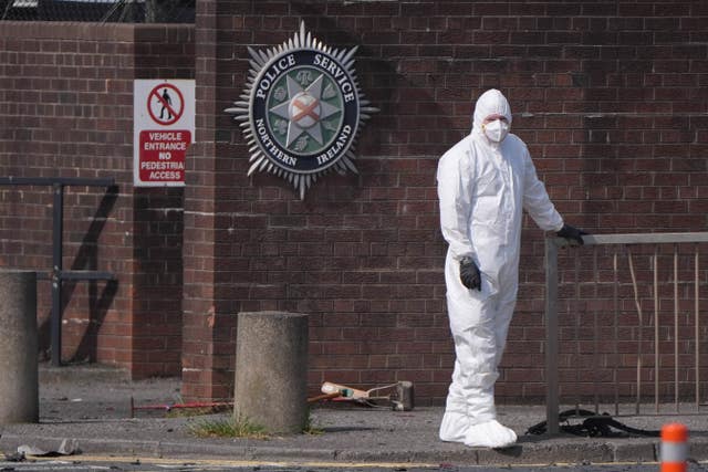 A forensic investigator at the scene in Dunmurry after a car exploded outside a police station