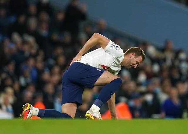 Harry Kane holds his back during the win over Manchester City