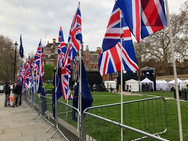 A row of Union flags in a spot usually occupied by EU flags opposite the Houses of Parliament (Ted Hennessey/PA)