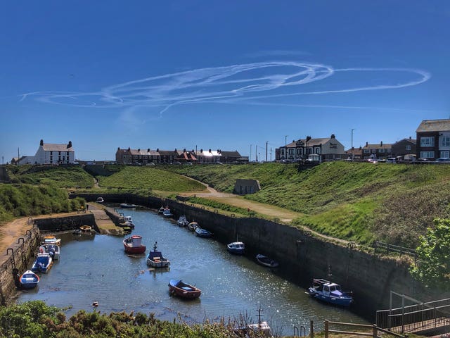 Pilots were also taking a spin in the blue skies (Owen Humphreys/PA)