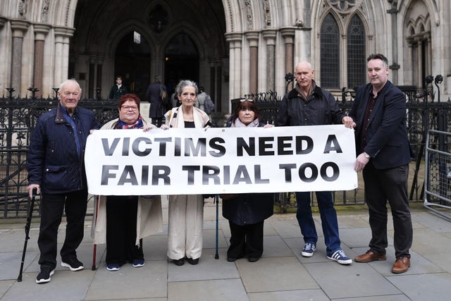 Barry Laycock, left, who was injured in a bombing in Manchester in 1996, with others holding a banner