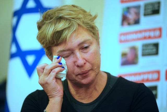 Iris Haim, the mother of Israeli hostage Yotam Haim currently being held in Gaza, wipes her eye during a press conference at the Israel embassy in London 