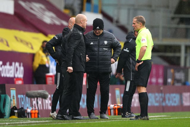 Referee Graham Scott (right) speaks with both managers following the incident at Turf Moor