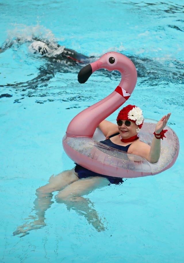 Nicole Foster swims in a rubber flamingo at Hillingdon Lido in Uxbridge, west London, on the first day of a major easing of England's coronavirus lockdown