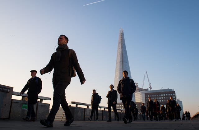 Commuters cross London Bridge before lockdown was enforced (Dominic Lipinski/PA)