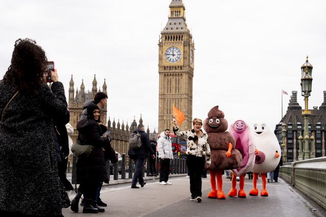  TV presenter Clare Balding with Stand Up To Cancer mascots on Westminster Bridge