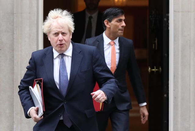 Boris Johnson (left) and Rishi Sunak leave 10 Downing Street 