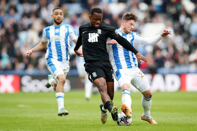 Birmingham’s Ethan Laird, left, battles for possession with Huddersfield’s Ben Wiles