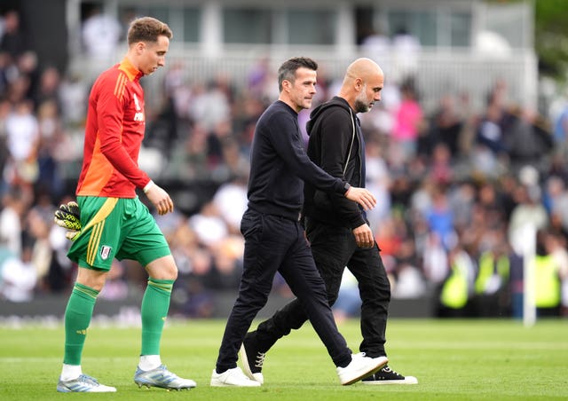 Fulham manager Marco Silva and Manchester City manager Pep Guardiola walk across the pitch