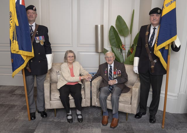 D-Day veteran Eric Suchland, with his wife of 74 years Dinah, receives a guard of honour from members of the Royal British Legion, as he celebrates his 100th birthday