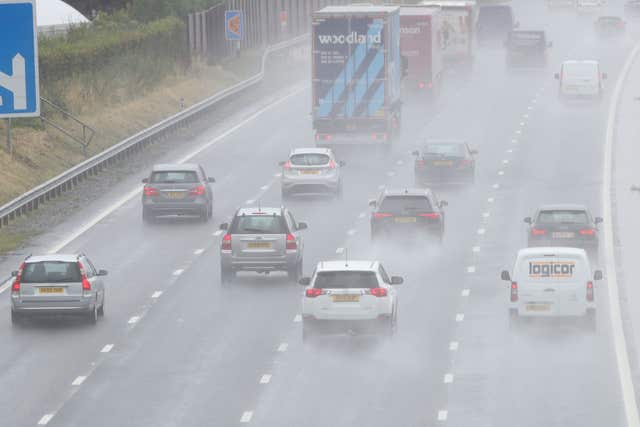 Cars travel through heavy rain on the M5 near Worcester on Thursday (Aaron Chown/PA)