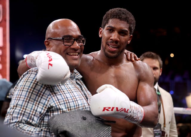 Joshua with his father Robert after reclaiming the IBF, WBA, WBO and IBO heavyweight titles