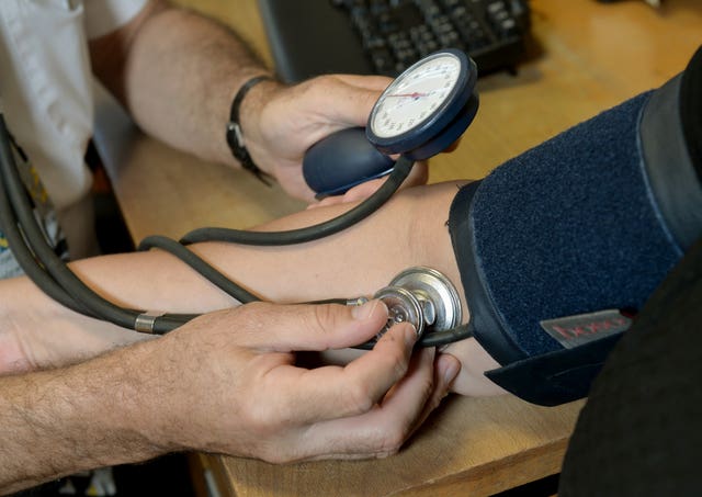 A GP checking a patient’s blood pressure (Anthony Devlin/PA)