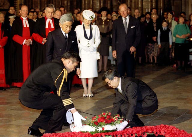 AKIHITO LAYS A WREATH