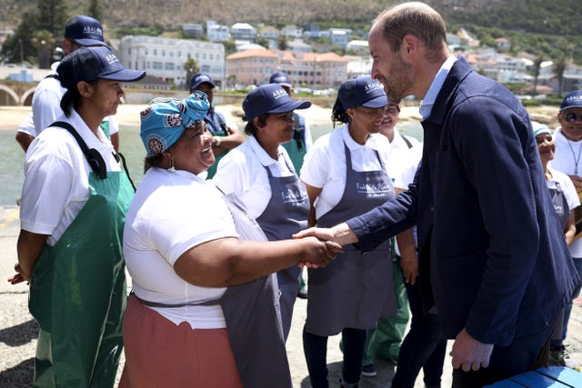 The Prince of Wales meeting local fishermen in Kalk Bay Harbour, Cape Town, to highlight the contributions of 2023 Earthshot finalist Abalobi, on the last day of his visit to South Africa