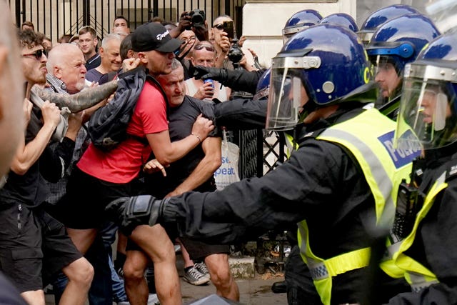 Police officers clash with protesters during the 'Enough is Enough' protest in Whitehall