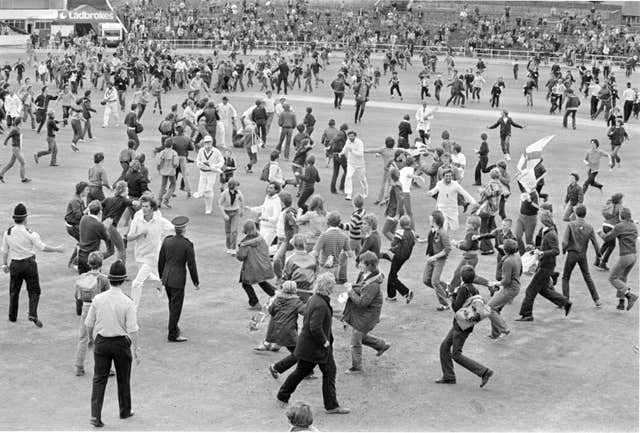 Fans stream on to the pitch to celebrate England's unlikely victory