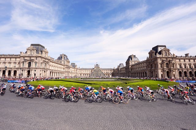 Riders cycling past the Louvre