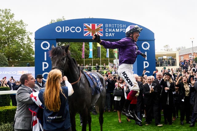 Frankie Dettori jumps off of King Of Steel as he celebrates winning the Champion Stakes