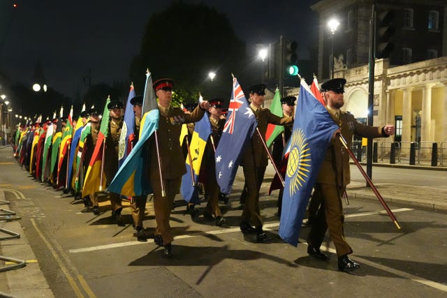 Flags of the Commonwealth are carried during the rehearsal