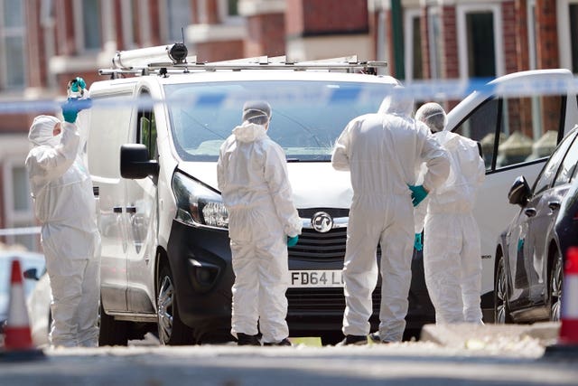 Police forensics officers search a white van on the corner of Maples Street and Bentinck Road in Nottingham