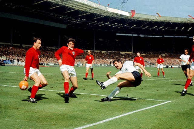 West Germany’s Lothar Emmerich (fourth l) fires a shot past England’s George Cohen (l)