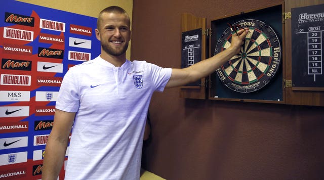 Eric Dier plays darts during the media access at Repino Cronwell Park 