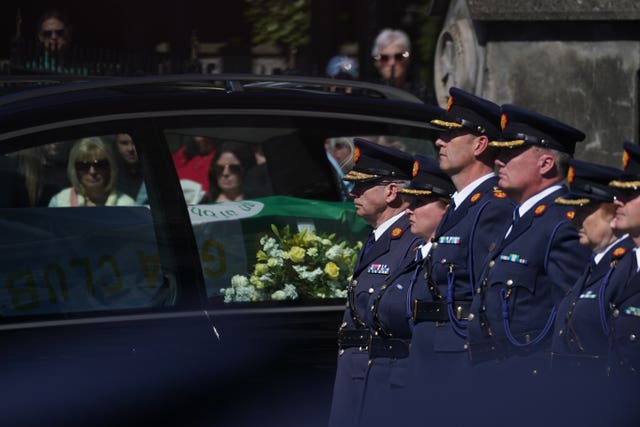 Garda colleagues, including Garda Commissioner Drew Harris (left) and members of the DMR roads policing unit, form a guard of honour for Garda Kevin Flatley, following his funeral service at St. Peter and Paul’s Church, Balbriggan, Co. Dublin on Friday