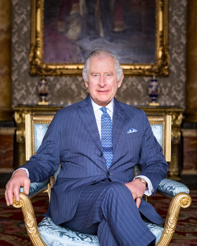 The King is wearing an Anderson and Sheppard suit and a Turnbull and Asser shirt and seated in a giltwood and silk upholstered armchair